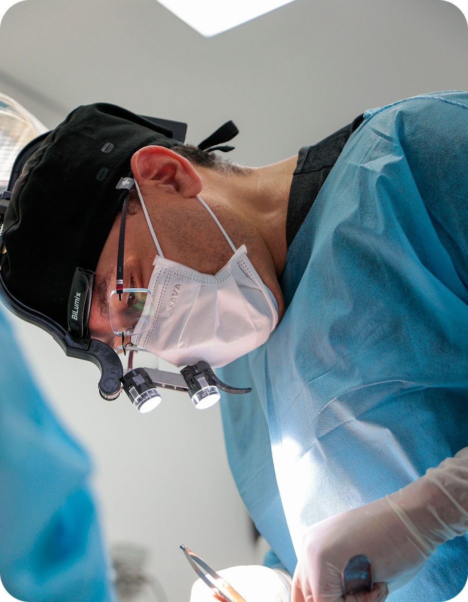 Dental professional performing implant surgery