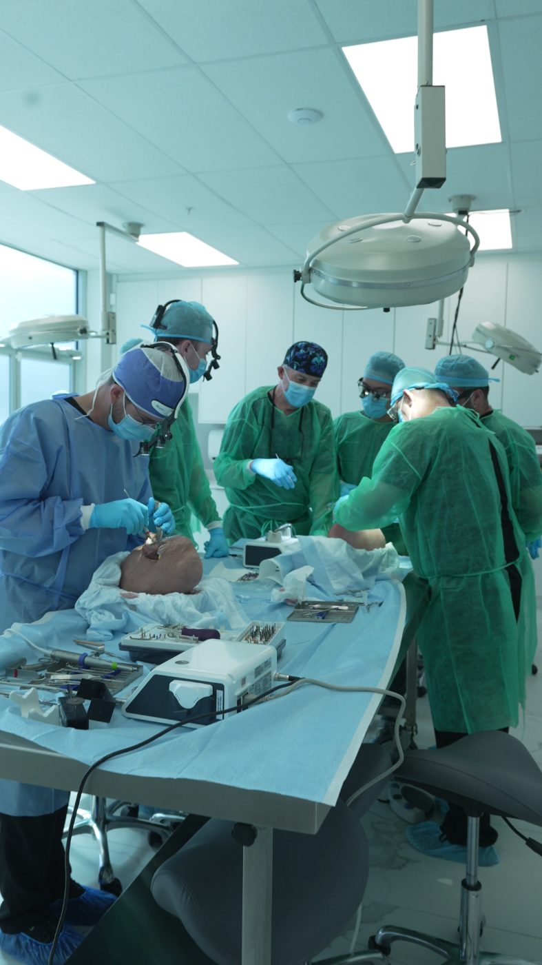 Cadaver lab surgery — full surgical team