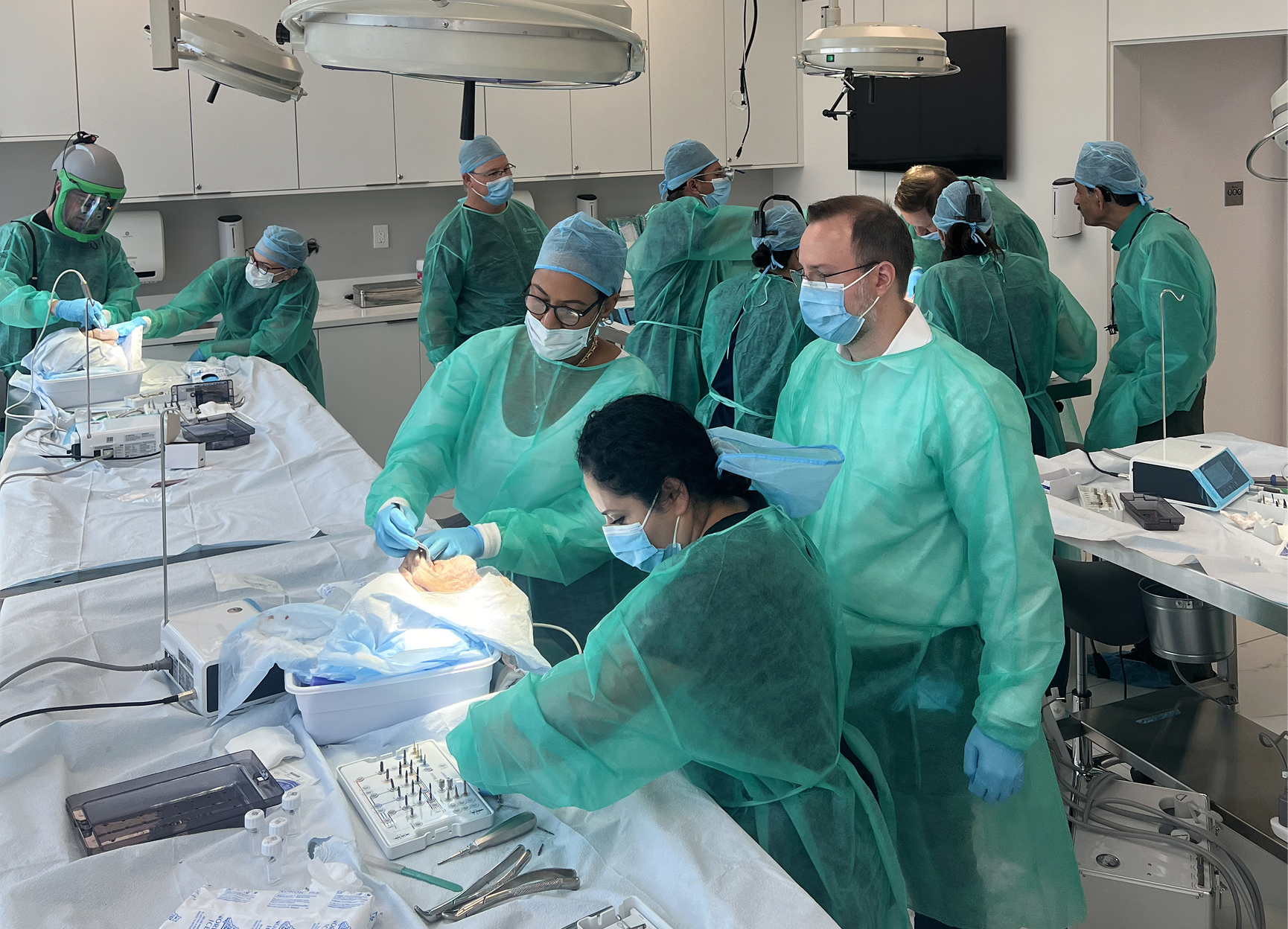 Close-up of hands-on cadaver training with surgical instruments